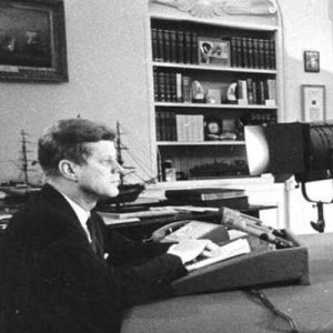 U.S. President John F. Kennedy speaks before reporters during a televised speech to the nation about the strategic blockade of Cuba, and his warning to the Soviet Union about missile sanctions, during the Cuban missile crisis, on October 24, 1962 in Washington, DC.