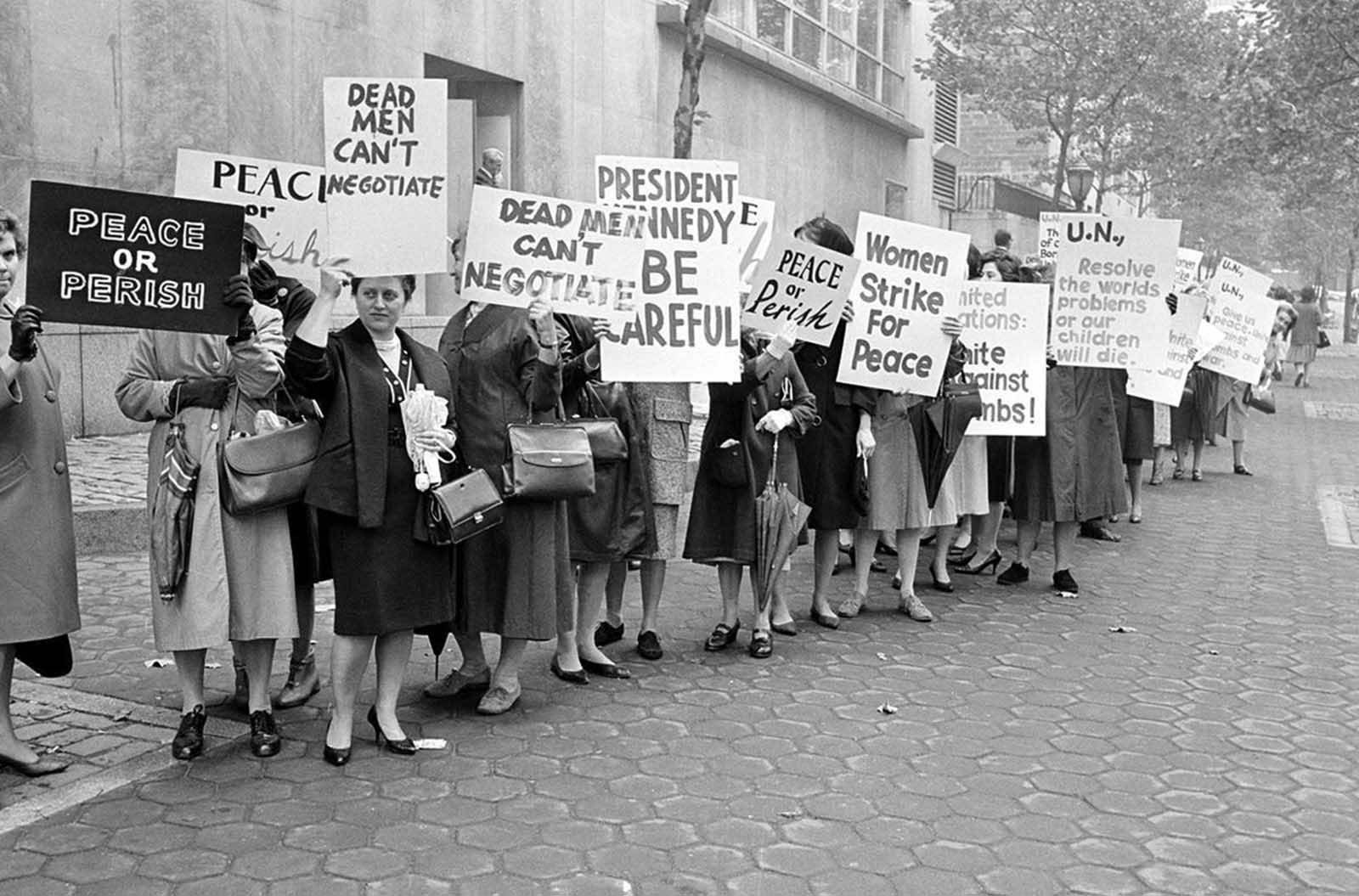 Picketers representing an organization known as Women Strike for Peace carry placards outside the United Nations headquarters in New York City, where the U.N. Security Council considers the Cuban missile crisis in a special meeting, on October 23, 1962.