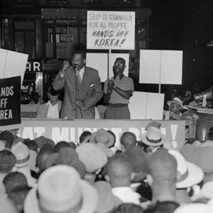 Singer Paul Robeson addresses a “Hands Off Korea” rally from a sound truck at the corner of 126th Street and Lenox Avenue in the Harlem section of New York, on July 3, 1950.