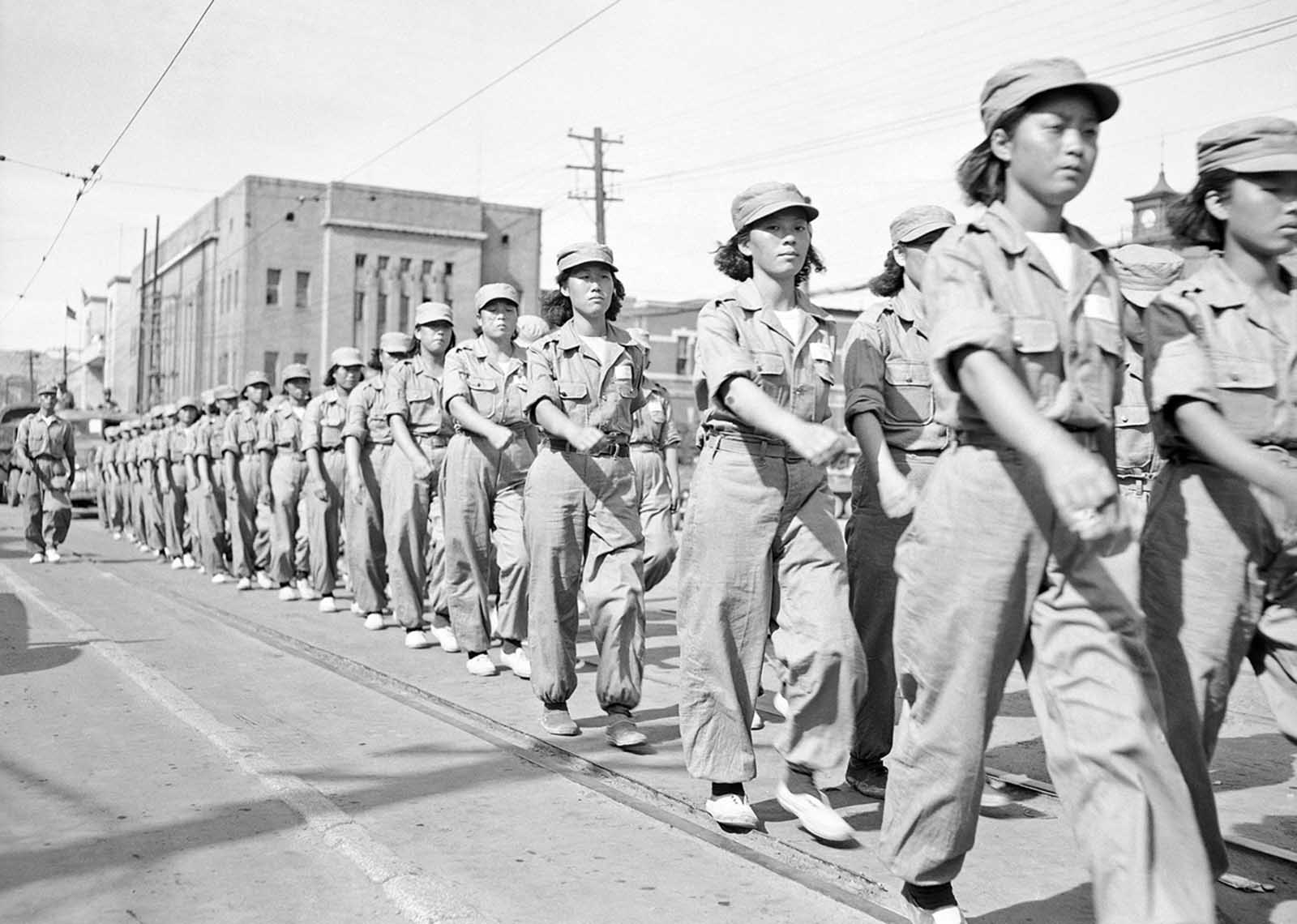 South Korean WACs trained and ready to join their men in the battle against Chinese invaders, display military precision as they parade through Pusan, main United Nations’ fort city in Korea, on September 12, 1950.