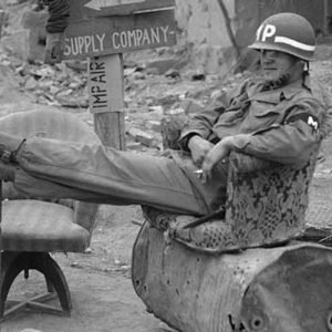 All Sgt. Bernard Young lacks is a private secretary to complete his “office” setting, on May 3, 1951. The Detroit, Michigan, military policeman takes his ease in almost deserted Chunchon, South Korea after the bulk of UN forces had withdrawn southward. Only an infantry rear guard unit remained between him and the advancing Communists.