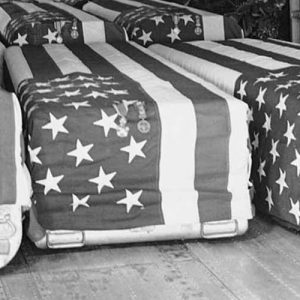Flag-draped coffins of eight American Servicemen killed in attacks on U.S. military installations in South Vietnam, on February 7, are placed in transport plane at Saigon, February 9, 1965, for return flight to the United States. Funeral services were held at the Saigon Airport with U.S. Ambassador Maxwell D. Taylor and Vietnamese officials attending.