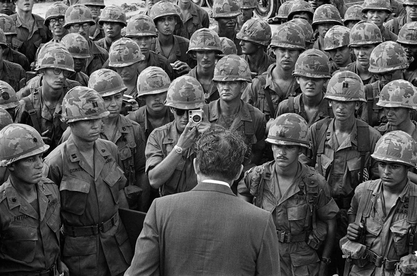 A GI gets a closeup photo as President Nixon meets with troops of the 1st Infantry Division at Di An, 12 miles northeast of Saigon, on his eighth visit to South Vietnam and his first as president, on July 30, 1969.