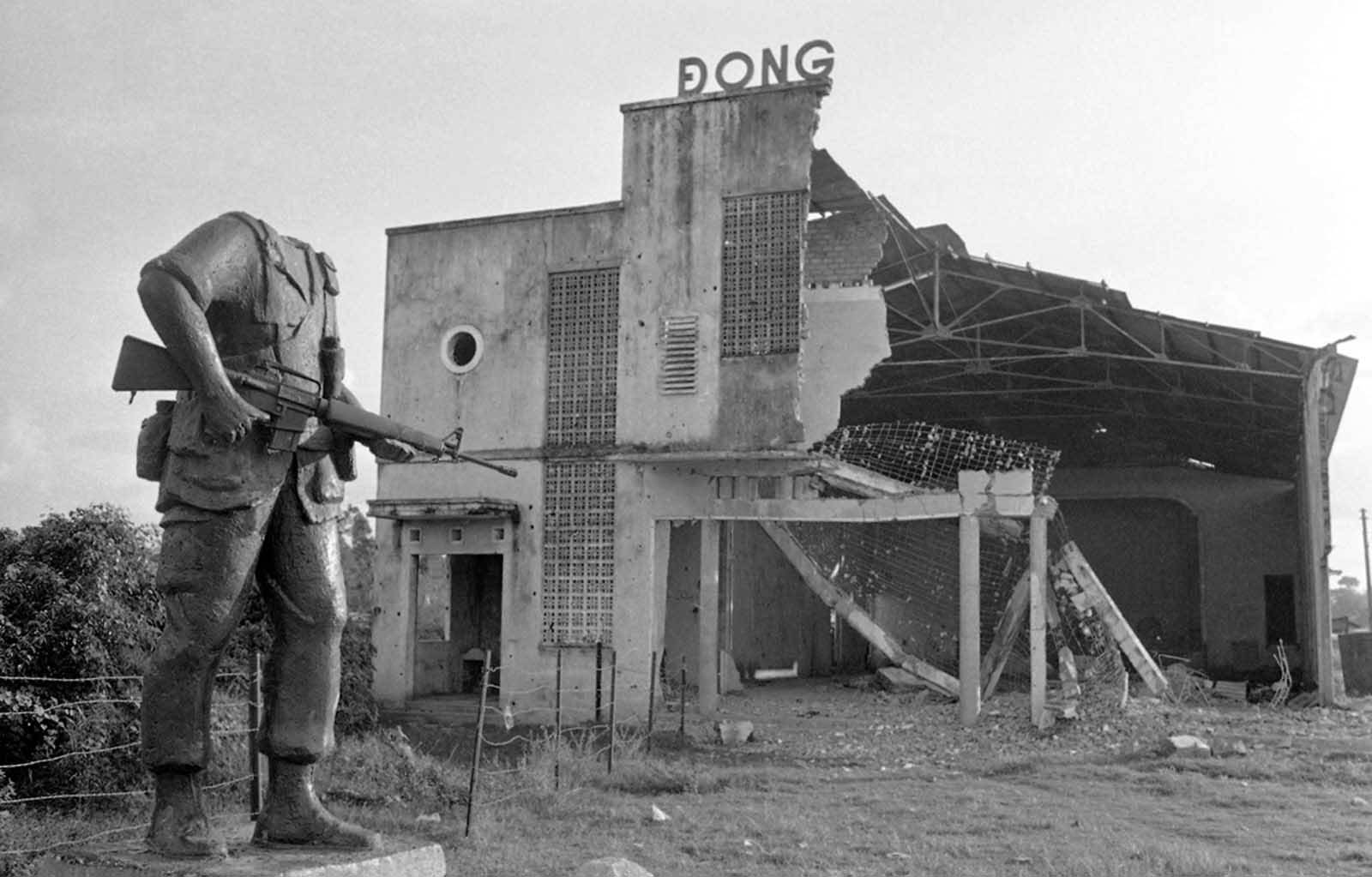 A beheaded statue of an American soldier stands next to a bombed-out theater near the district town of Cu Chi, northwest of Saigon, on December 13, 1972. The statue was placed by troops of the U.S. 25th Infantry Division before they were withdrawn from Vietnam two years earlier. Its head was lost in the explosion that destroyed the theater in background.